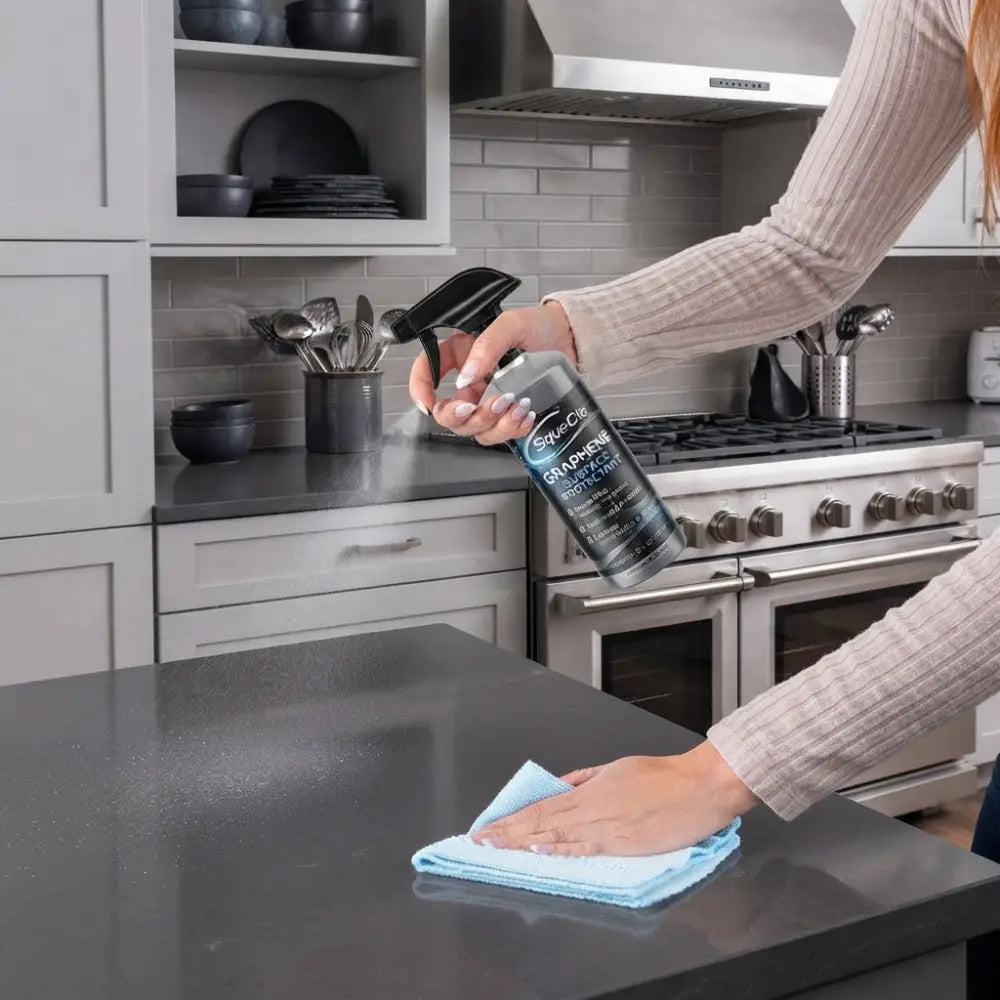woman spraying squecle graphene ceramic spray and wiping off with clothe